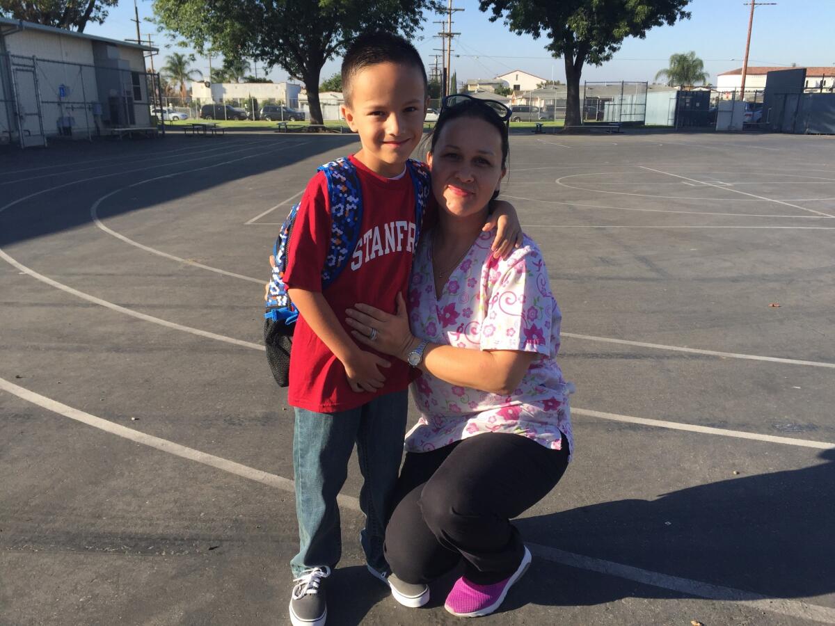 Alma Falcon drops off her third-grade son, Daniel, at Fourth Street Elementary School in East Los Angeles.