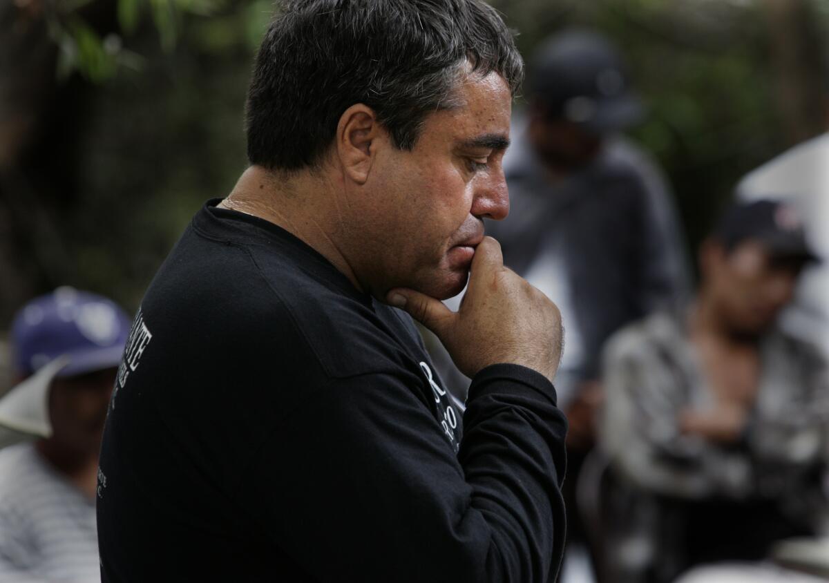 Enrique Morones listens during Sunday Mass at the makeshift Catholic Church in McGonigle Canyon
