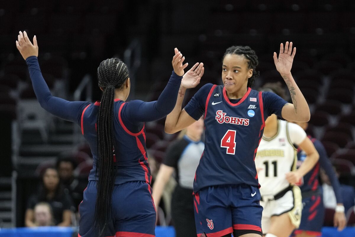 St. John's guard Jayla Everett (4) reacts after a basket with Mimi Reid (2) against Purdue in the second half of a First Four women's college basketball game in the NCAA Tournament Thursday, March 16, 2023, in Columbus, Ohio. (AP Photo/Paul Sancya)