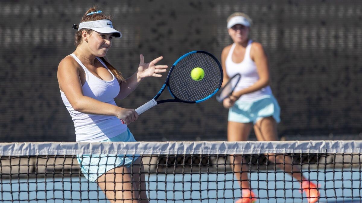 Corona del Mar High's Bella McKinney, left, returns a shot during doubles action with partner Shaya Northrup against Mater Dei on Sept. 5.