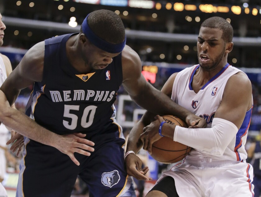 Clippers point guard Chris Paul tries to grab a loose ball from Grizzlies power forward Zach Randolph during a Nov. 18, 2013 game.