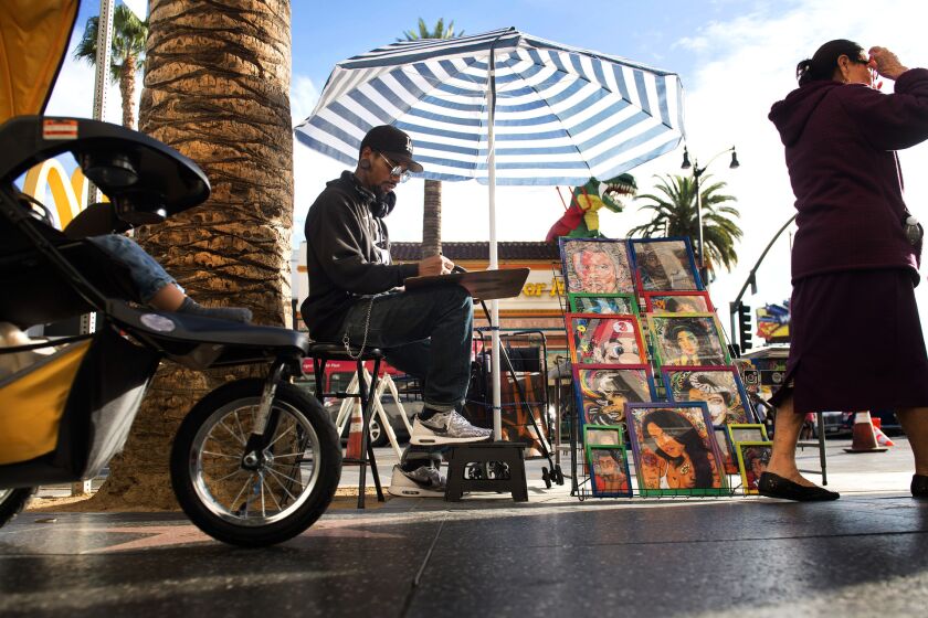 Christopher Stoute draws and sells his artwork on Hollywood Boulevard. Los Angeles is considering regulations that would ban sidewalk vending within 500 feet of Dodger Stadium, Hollywood Boulevard, Staples Center and other venues. City officials said the regulations would not affect people selling their own art or "expressive" items.