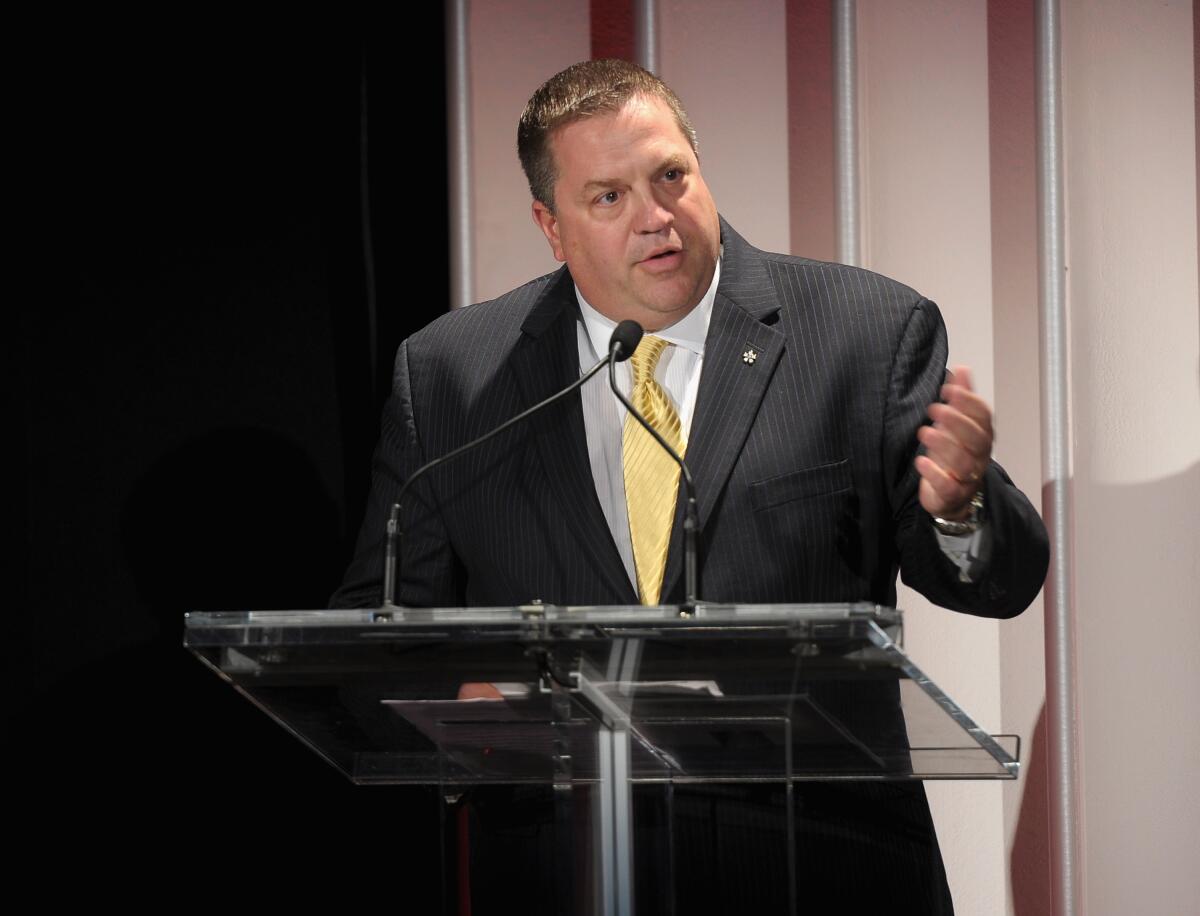 A man speaks at a lectern