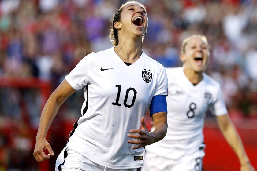 U.S. midfielder Carli Lloyd (10) and forward Amy Rodriguez (8) celebrate after Lloyd scored against China six minutes into the second half of a Women's World Cup quarterfinal game.