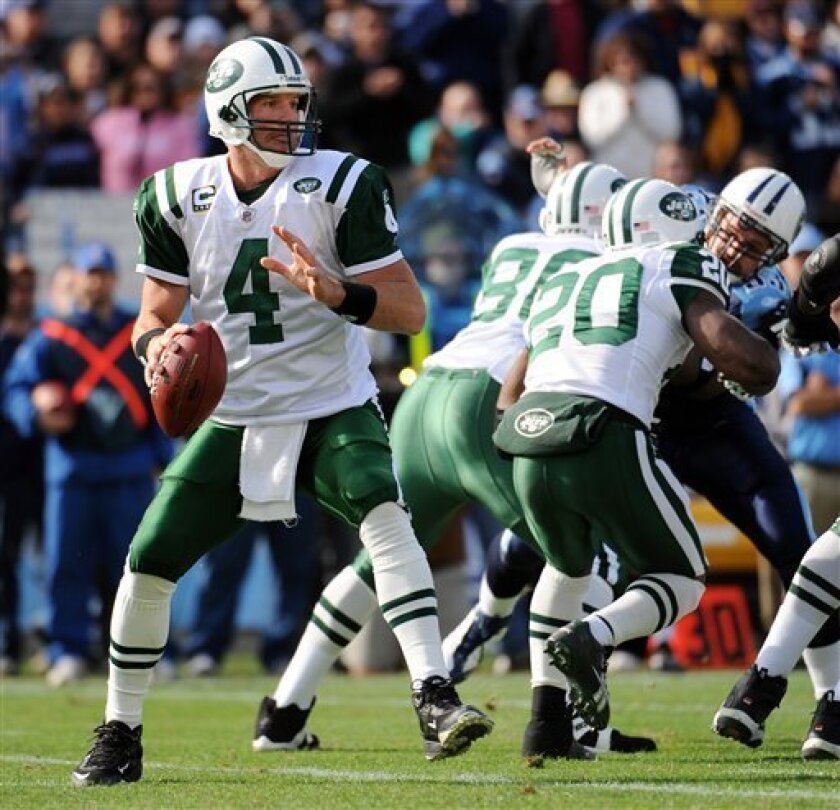 New York Jets quarterback Brett Favre (4) looks for a receiver as Jets running back Thomas Jones (20) and tight end Chris Baker (86) block Tennessee Titans defensive end Kyle Vanden Bosch, right, in the first quarter of an NFL football game in Nashville, Tenn., Sunday, Nov. 23, 2008. (AP Photo/John Russell)