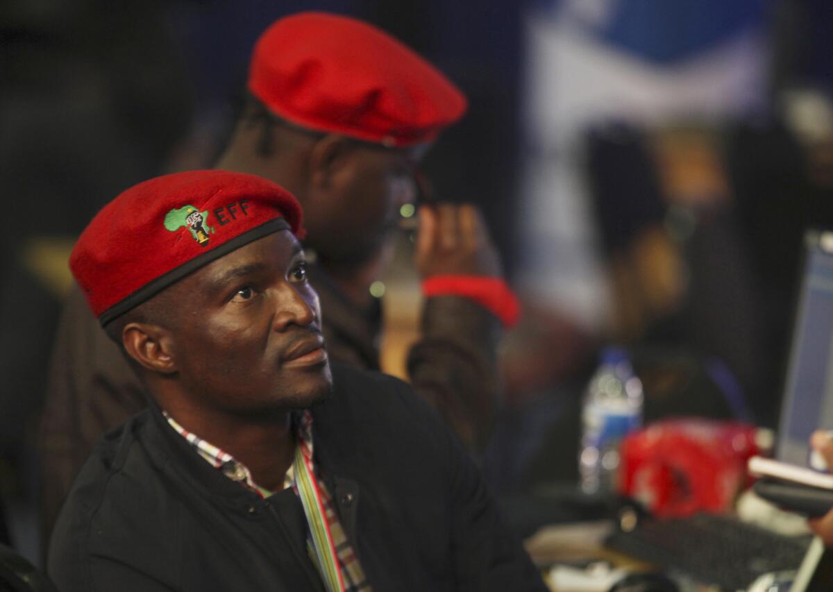Members of the new Economic Freedom Fighter party monitor early results of South African elections in Pretoria.