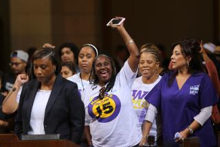 FILE - In this May 19, 2015, file photo, Laphonza Butler, President of SEIU ULTCW, the United Long Term Care Workers Union, far left, joins workers demanding the Los Angeles City Council to vote to raise the minimum wage. The council gave initial approval to raising minimum pay in the nation's second-largest city to $15 an hour by 2020. SEIU's state council announced an initiative Tuesday, Nov. 3, 2015, that would raise the minimum wage to $15 an hour by 2020 and require at least six paid sick days a year, double the number now offered to low-wage workers. Meanwhile, SEIU's United Healthcare Workers West already has been gathering signatures for a separate measure that would raise the minimum wage by $1 an hour until it hits $15 an hour in 2021. (AP Photo/Damian Dovarganes, File)