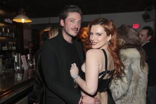 Actor Bella Thorne, right, and Mark Emms, left, pose at the "Divinity" Premiere Party At The Latinx House with Flaunt Magazine, Pop Culture Collaborative, and Entropy at The Sundance Film Festival inside the Latinx House on Saturday Jan. 21, 2023 in Park City. (Photo by Danny Moloshok/Invision for The Latinx House/AP Images)