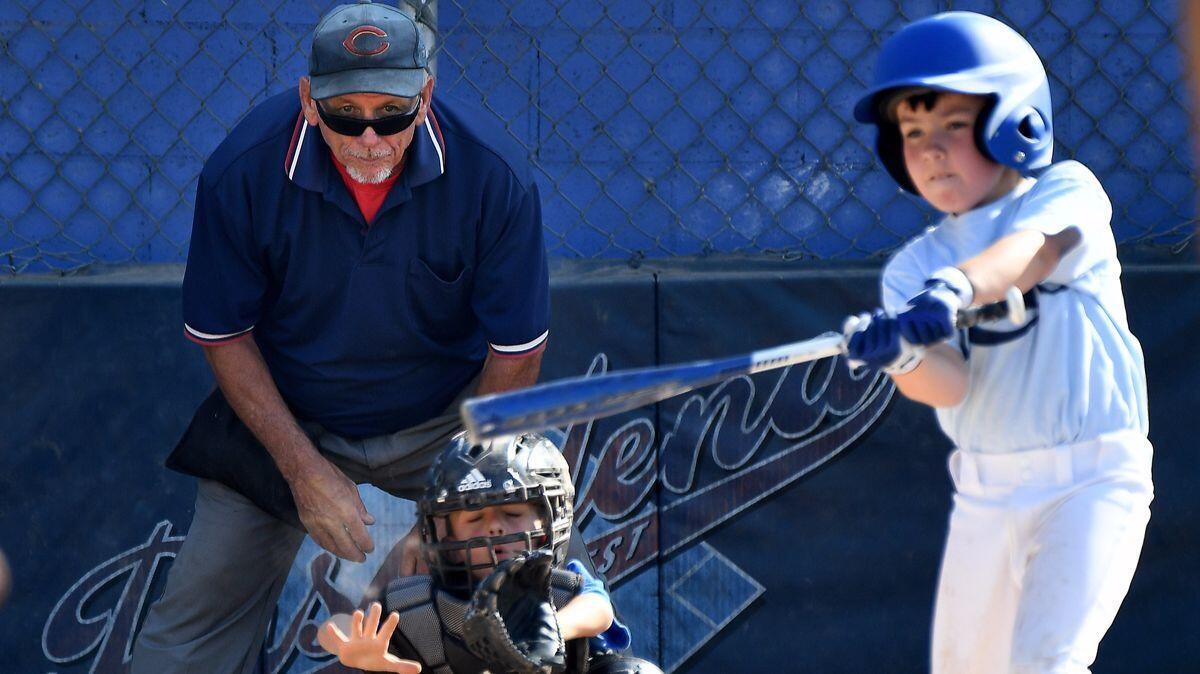 Umpire Pete Constantino stands behind home plate during a Southwest Pasadena little league game. Constantino has been an umpire for 40 years.