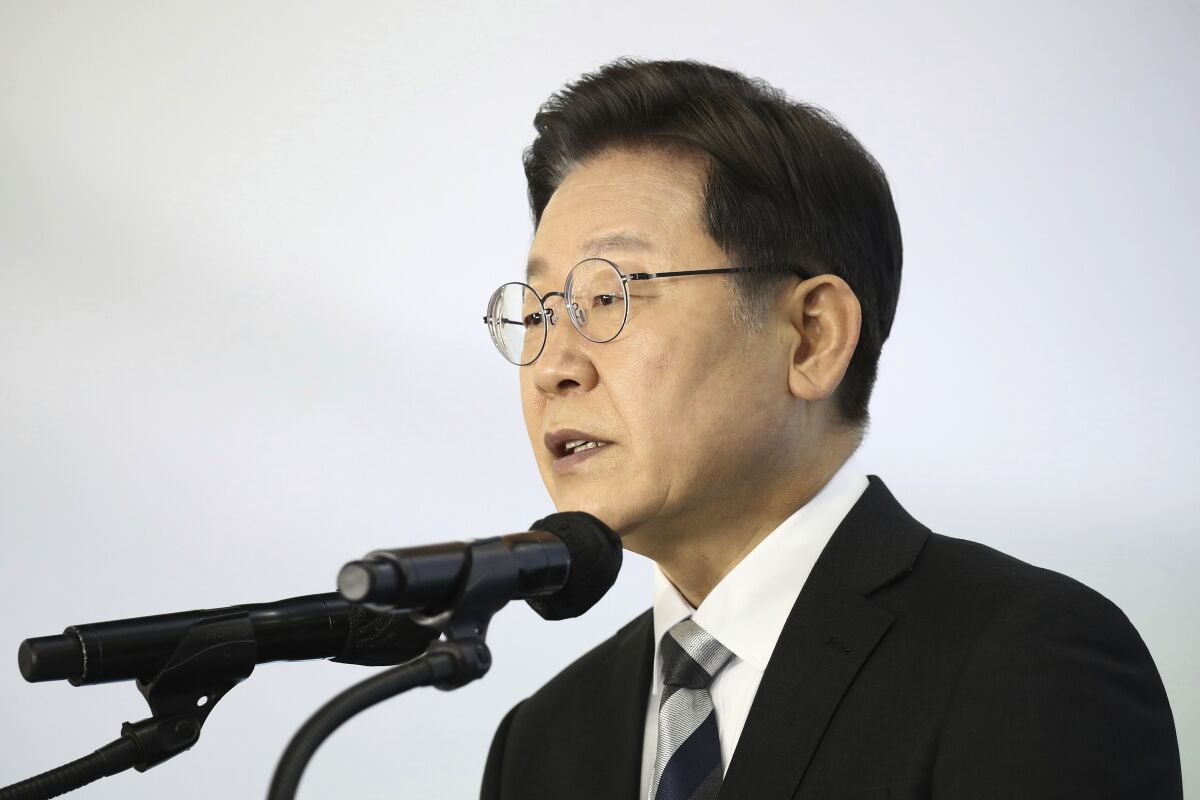 Lee Jae-myung, a candidate of the ruling Democratic Party for next March's presidential election, speaks during a New Year press conference at a Kia Motors' plant in Gyeonggi-do, South Korea Tuesday, Jan. 4, 2022. (Chung Sung-Jun/Pool Photo via AP)