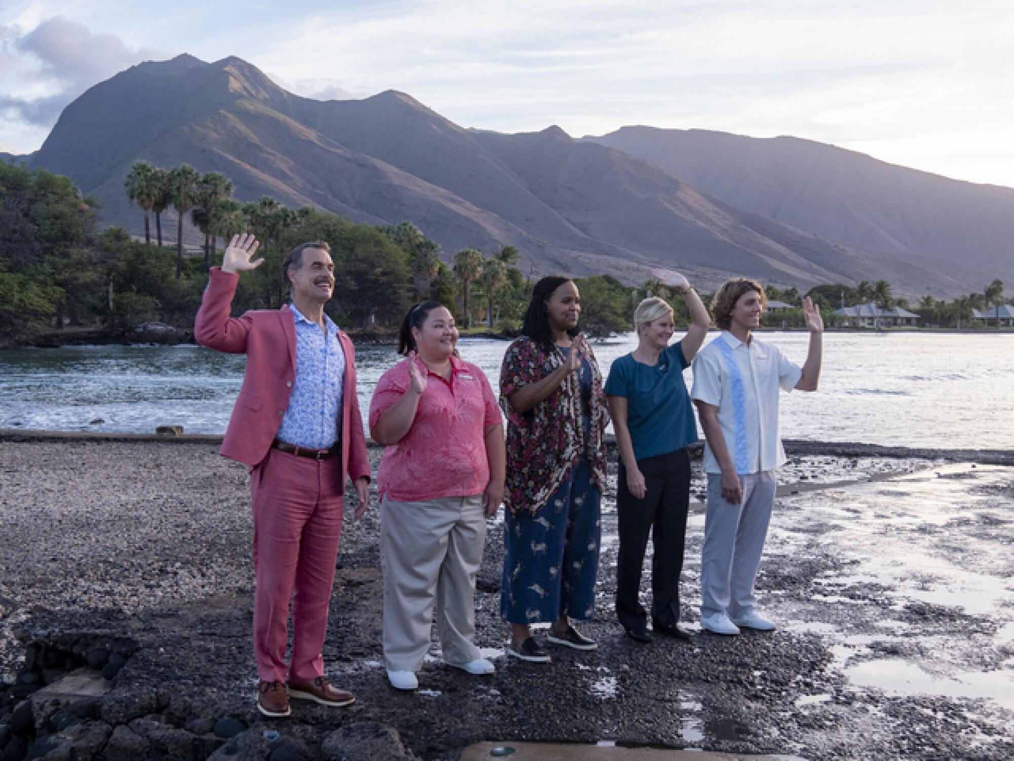 A group of people stand on a shore 