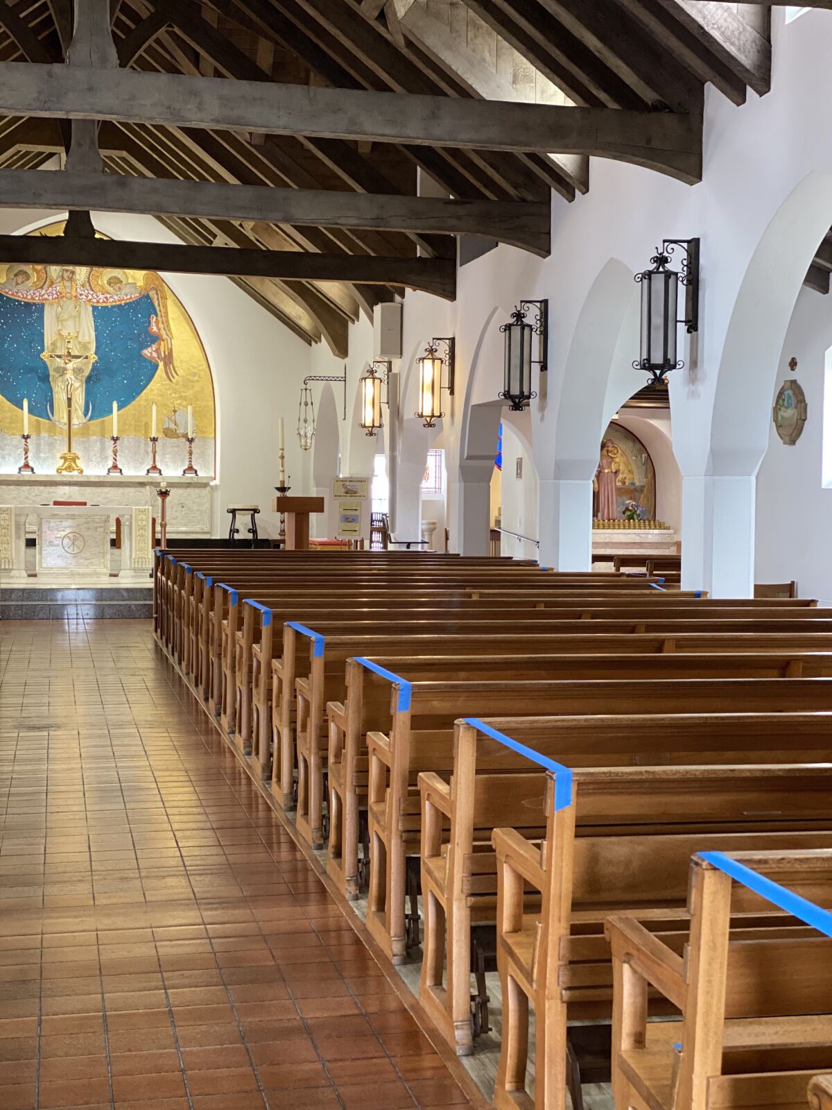 Mary, Star of the Sea Catholic Church has blocked off every other pew and added signs on the doors to indicate new guidelines for returning to the church for in-person services.