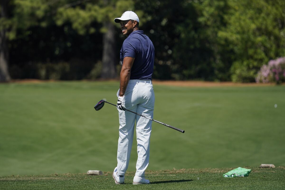 Tiger Woods waits to hit on the driving range during a practice round for the Masters tournament on Monday.