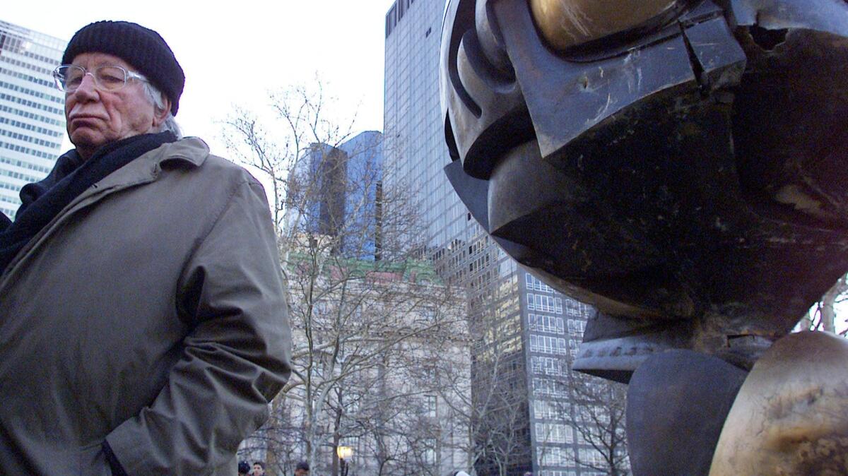 German artist Fritz Koenig stands next to his bronze sculpture "The Sphere" after a dedication ceremony in New York in 2002.