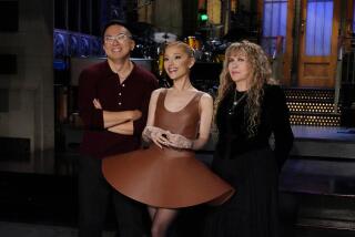 Cast member Bowen Yang, host Ariana Grande and musical guest Stevie Nicks on the set of "Saturday Night Live."