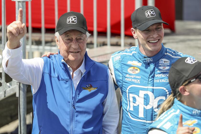 FILE - Team Penske driver Josef Newgarden, right, celebrates his victory with team owner Roger Penske after the IndyCar Grand Prix of St. Petersburg auto race, Sunday, March 10, 2024, in St. Petersburg, Fla. Team Penske suffered a humiliating disqualification Wednesday, April 24, when reigning Indianapolis 500 winner Josef Newgarden was stripped of his victory in the season-opening race for manipulating his push-to-pass system. Penske teammate Scott McLaughlin, who finished third in the opener on the downtown streets of St. Petersburg, Florida, was also disqualified. (AP Photo/Mike Carlson, File)