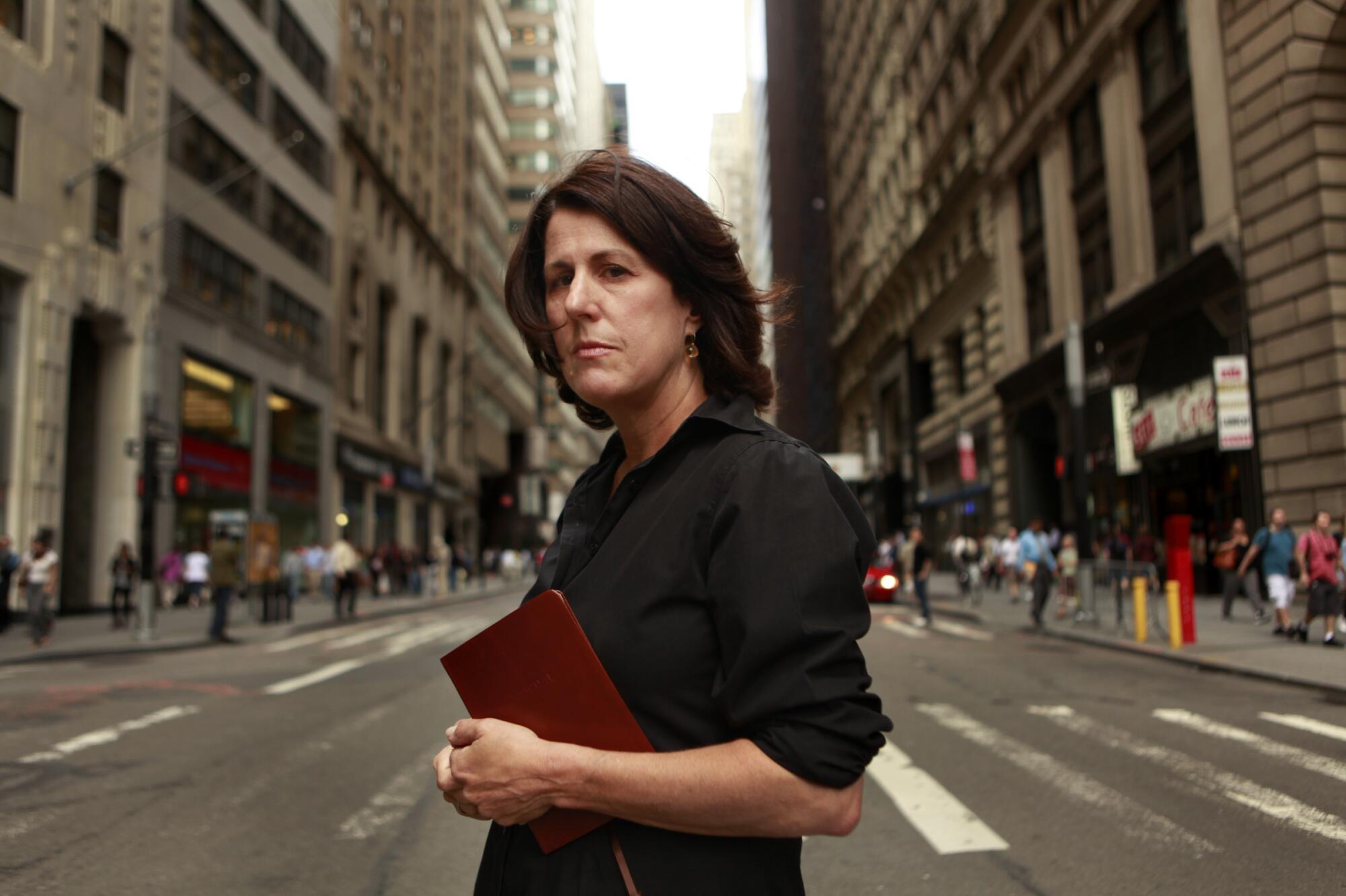 Geraldine Baum holds a diary while standing on a New York street