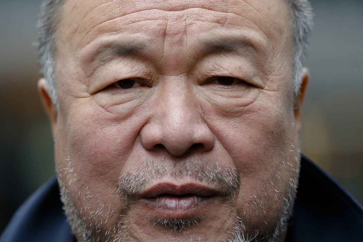 FILE - Chinese contemporary artist and activist Ai Weiwei poses for a portrait prior to a news conference in Berlin, Germany, Sept. 2, 2020. Weiwei helped design Beijing's Bird's Nest stadium for the 2008 Olympics. It's again the venue for the opening ceremony of the 2022 Beijing Winter Olympics. (AP Photo/Markus Schreiber, File)