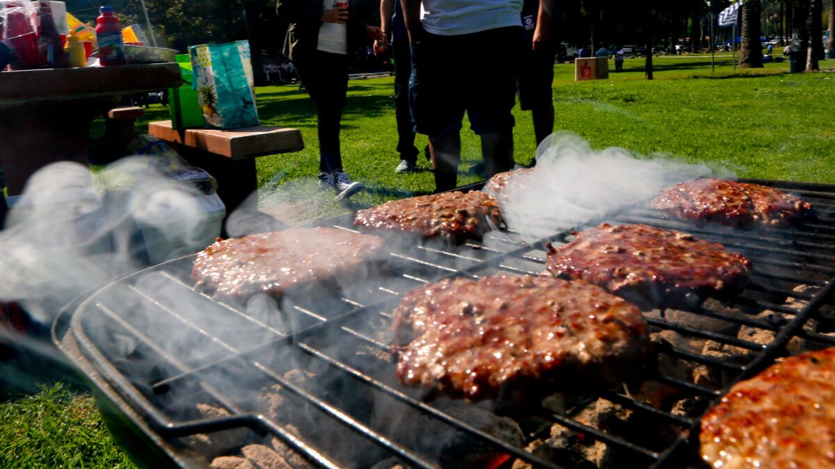 Classic burgers on the grill at a tailgate party. Beyond Meat, a company based in El Segundo, is planning to launch plant-based burgers at grocery stores in Los Angeles later this year.