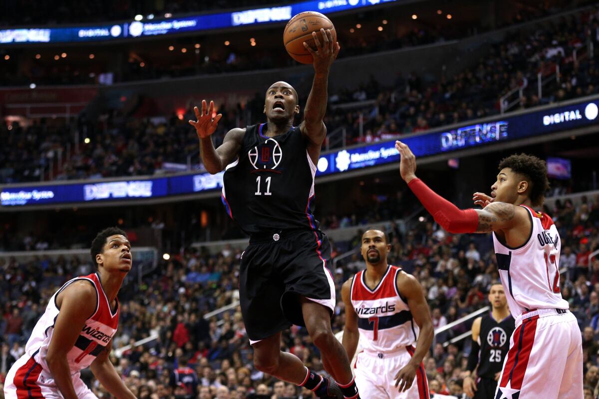 Clippers guard Jamal Crawford attempts a layup in front of Kelly Oubre Jr. and other Wizards defenders during the first half.