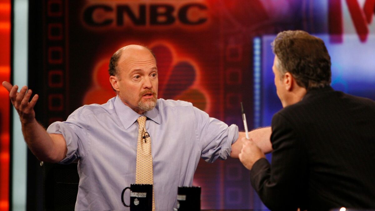 Jim Cramer, left, host of "Mad Money" on CNBC and co-founder of TheStreet Inc., talks with Jon Stewart during an appearance on Comedy Central's "The Daily Show" in 2009.