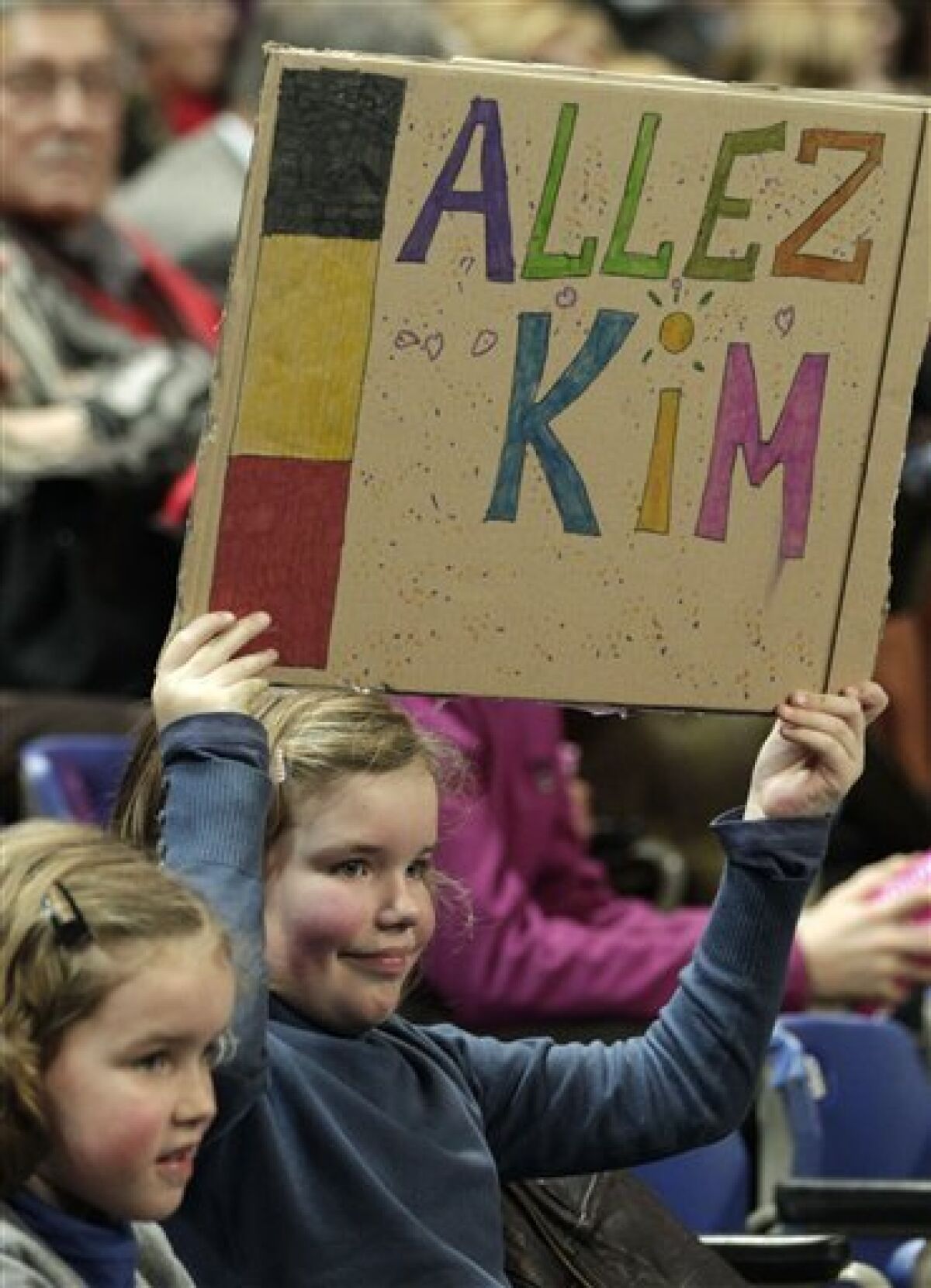 A young supporter of Belgium's Kim Clijsters holds up a placard during the World Group Fed Cup match Belgium versus USA, in Antwerp, Belgium, Saturday, Feb. 5, 2011. Belgium leads on the first day 2-0. (AP Photo/Yves Logghe)
