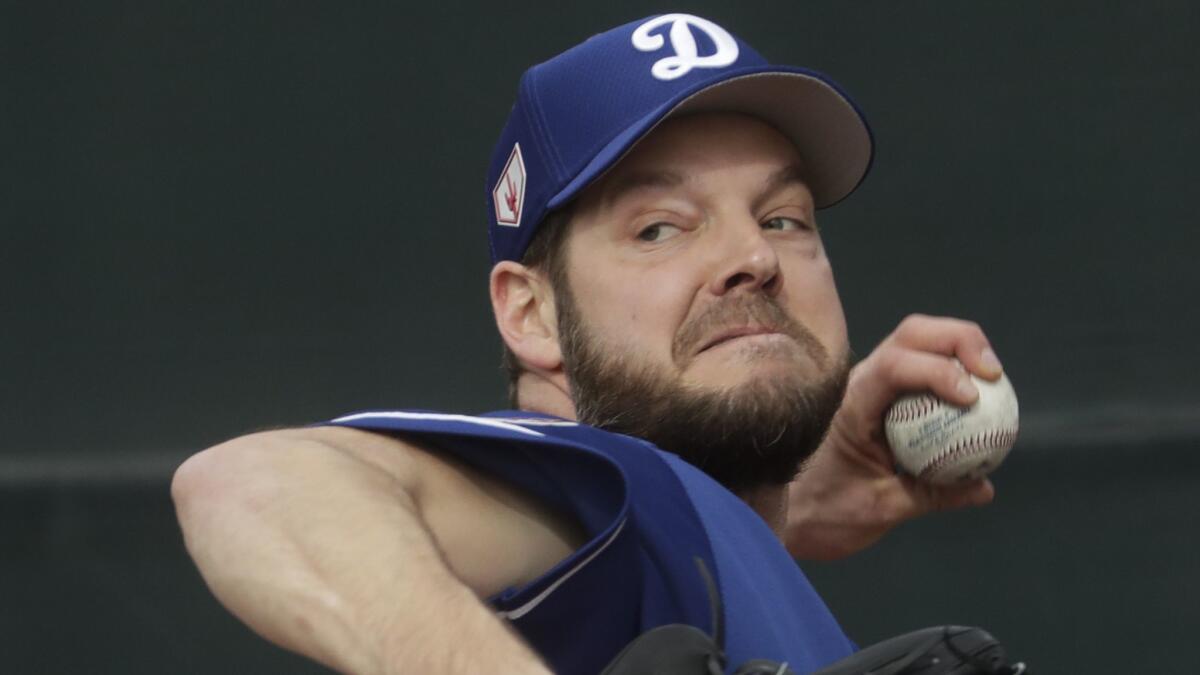 Dodgers' Rich Hill throws during a spring training workout on Feb. 13 in Glendale, Ariz.