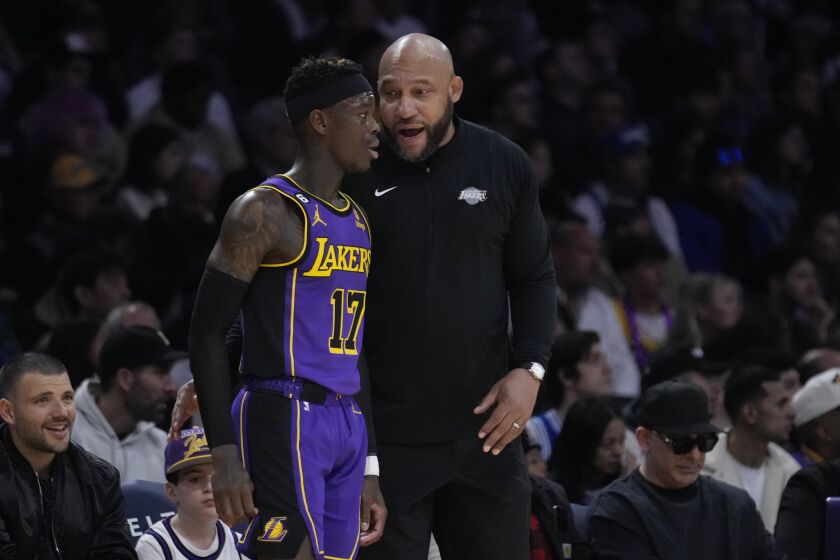Los Angeles Lakers head coach Darvin Ham, right, talks to guard Dennis Schroder (17) during the first half of an NBA basketball game against the Dallas Mavericks Friday, March 17, 2023, in Los Angeles. (AP Photo/Marcio Jose Sanchez)
