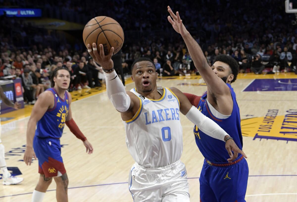 Lakers guard Russell Westbrook drives to the basket ahead of Denver's Jamal Murray.