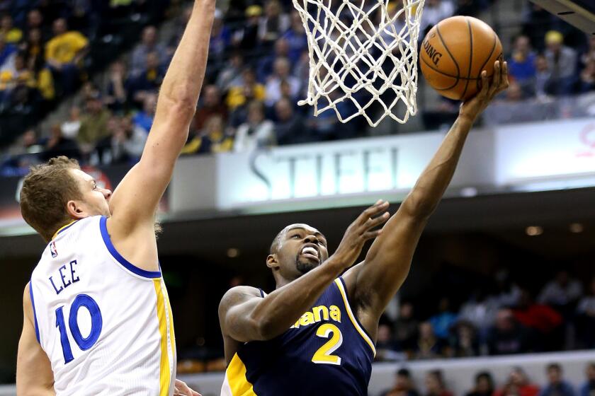 Pacers guard Rodney Stuckey has his layup challenged by Warriors forward David Lee during their game Sunday in Indianapolis.