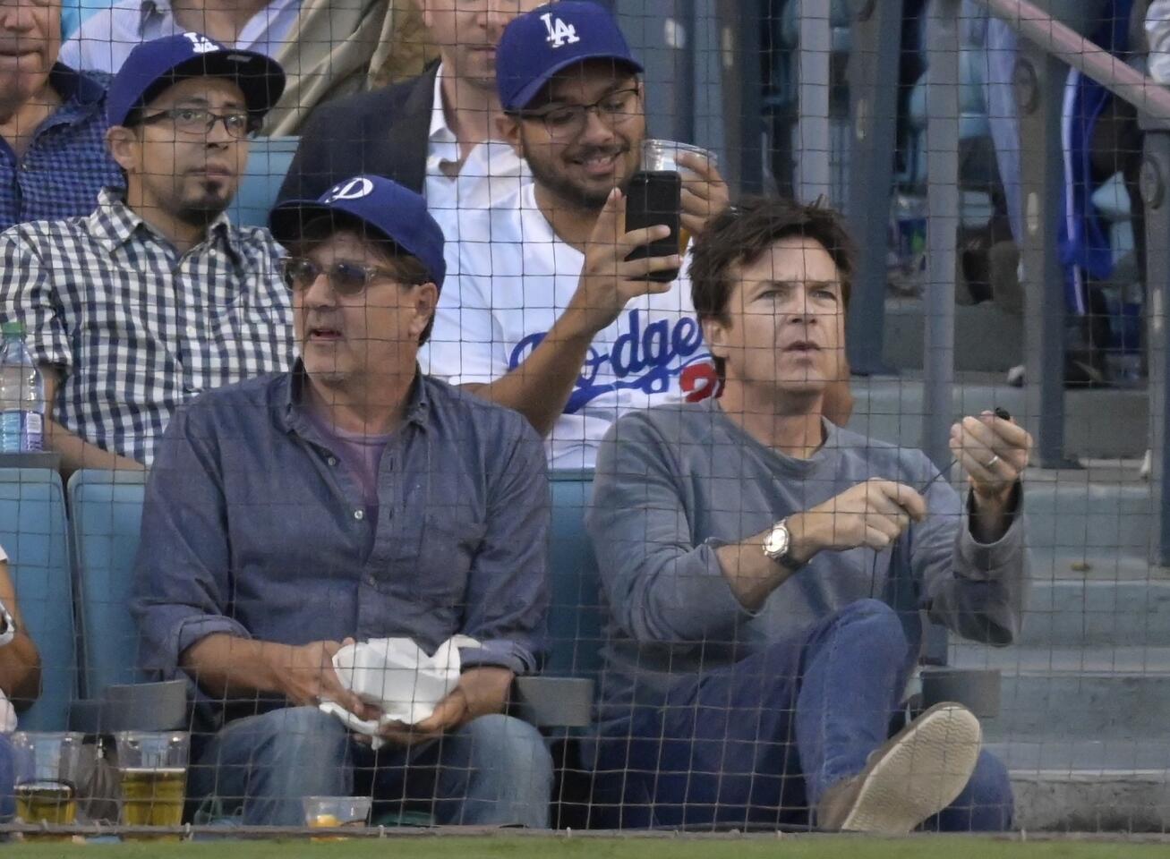 Actor Jason Bateman watches during the third inning of Game 3 of the National League Championship Series baseball game between the Milwaukee Brewers and the Los Angeles Dodgers Monday, Oct. 15, 2018, in Los Angeles. (AP Photo/Mark J. Terrill)