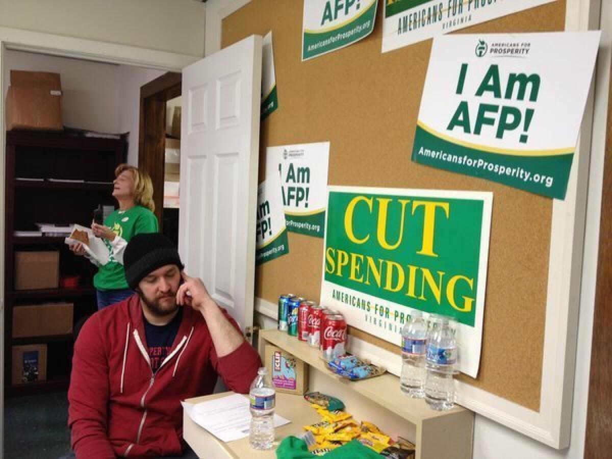 Scott Jackson, 30, calls voters at an election day phone bank run by Americans for Prosperity in Virginia.