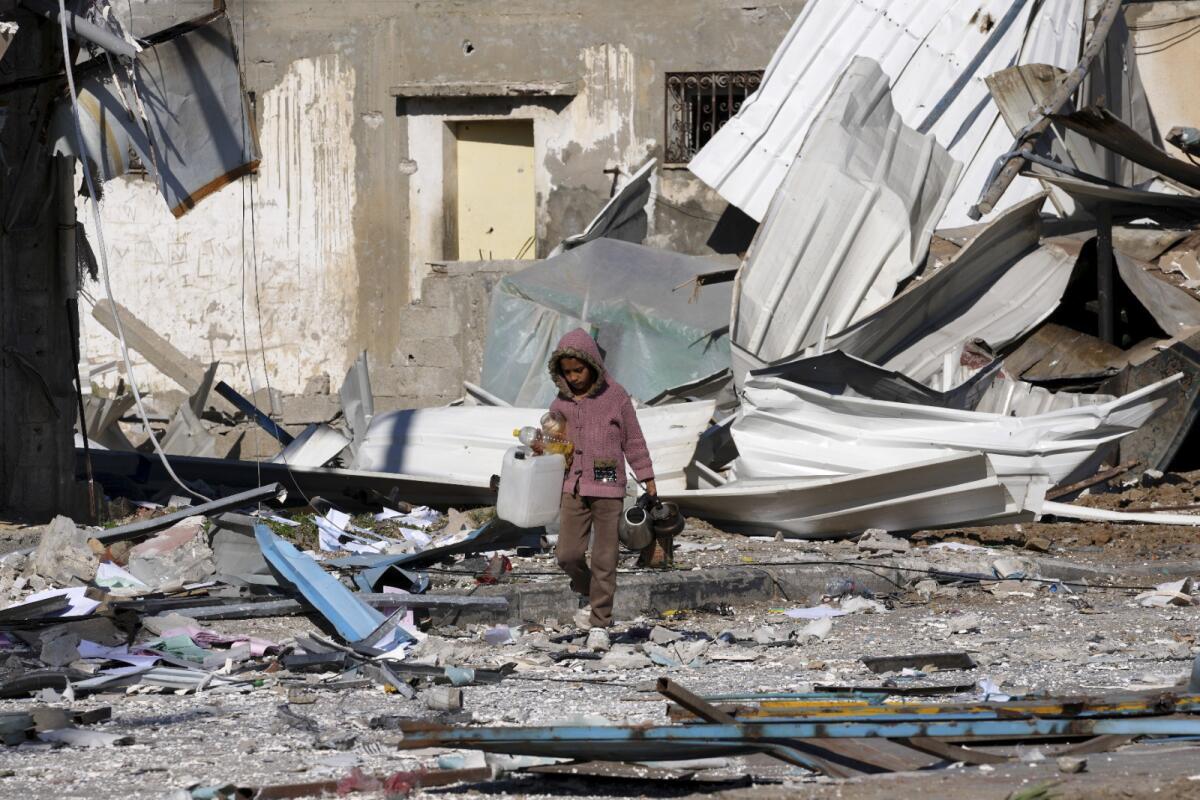 A child walked in rubble of a destroyed building.