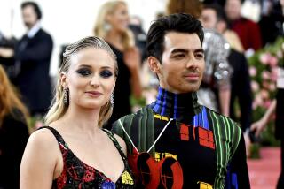 Sophie Turner and Joe Jonas wearing matching colorful outfits at the Met Gala