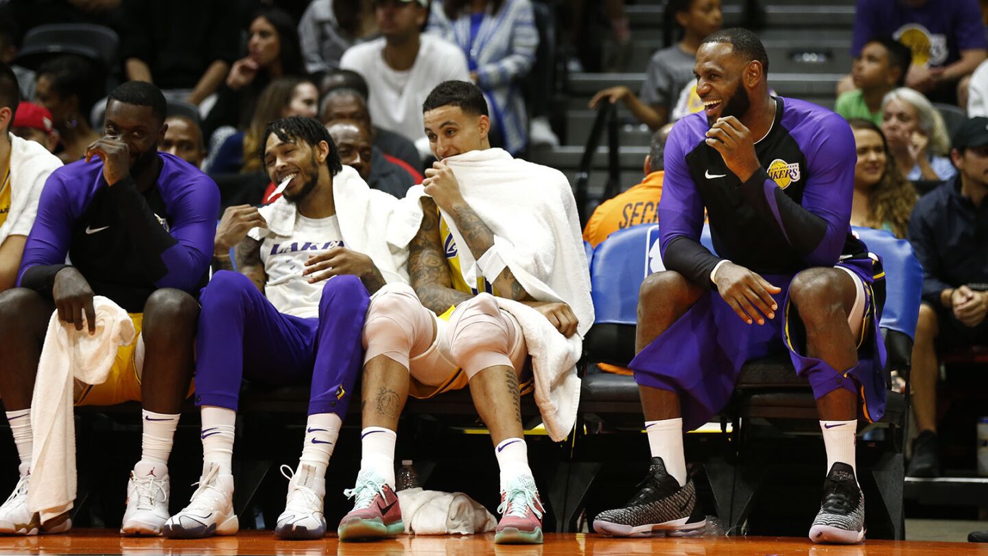 Los Angeles Lakers LeBron James, right, laughs with teammates during a game against the Denver Nuggets in San Diego on Sunday, September 30, 2018. (Photo by K.C. Alfred/San Diego Union-Tribune)