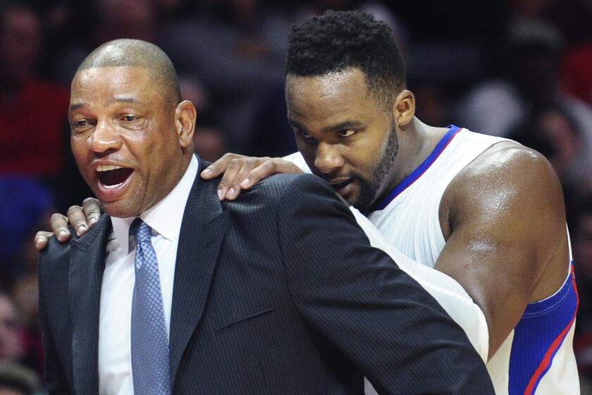 Clippers Coach Doc Rivers, left, and forward Glen Davis share a laugh during a win over the Sacramento Kings at Staples Center on Feb. 21.