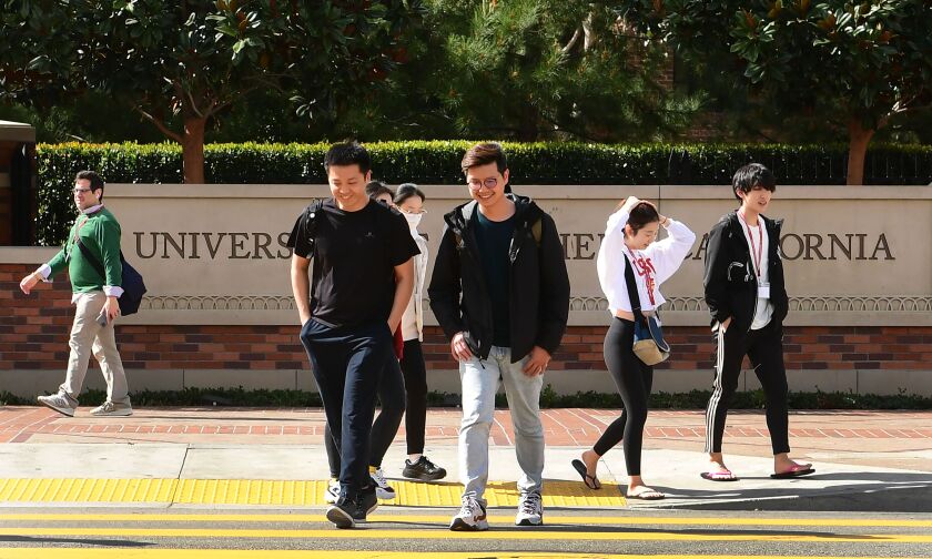 Students cross a crosswalk at the University of Southern California (USC) in Los Angeles.