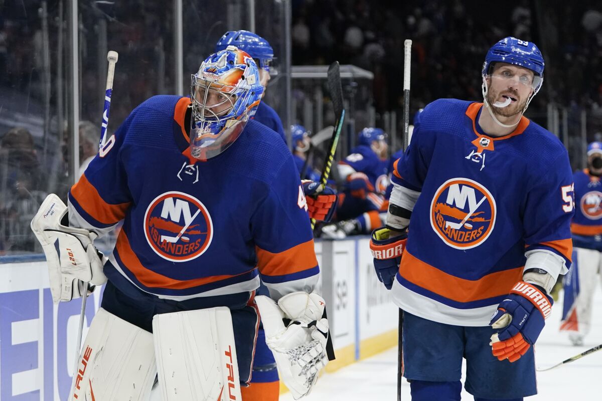 New York Islanders goaltender Semyon Varlamov (40) and Casey Cizikas (53) leave the ice after Game 3 during an NHL hockey second-round playoff series against the Boston Bruins Thursday, June 3, 2021, in Uniondale, N.Y. The Bruins won 2-1. (AP Photo/Frank Franklin II)