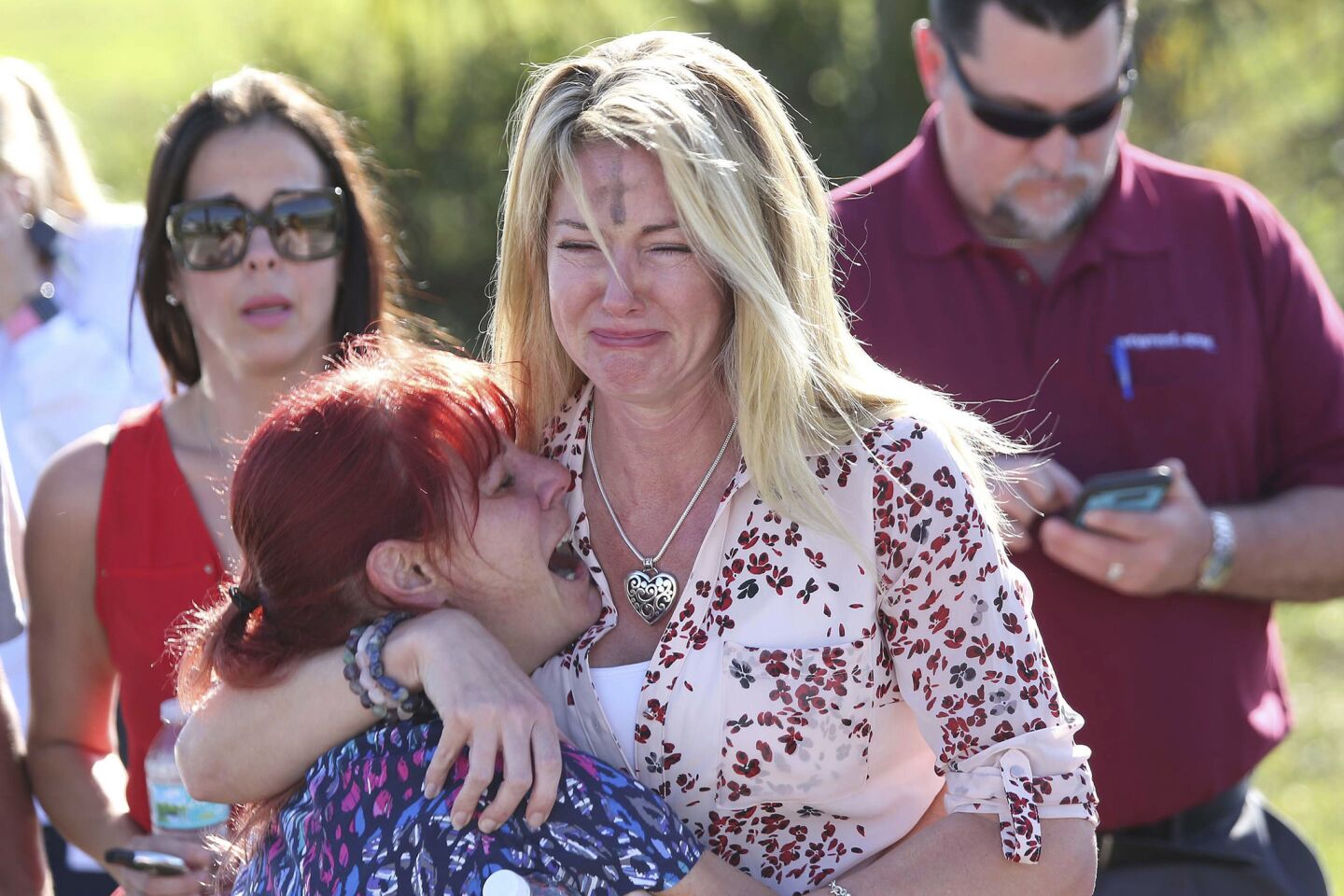 Parents wait for news after a shooting at Marjory Stoneman Douglas High School in Parkland, Fla., on Wednesday.