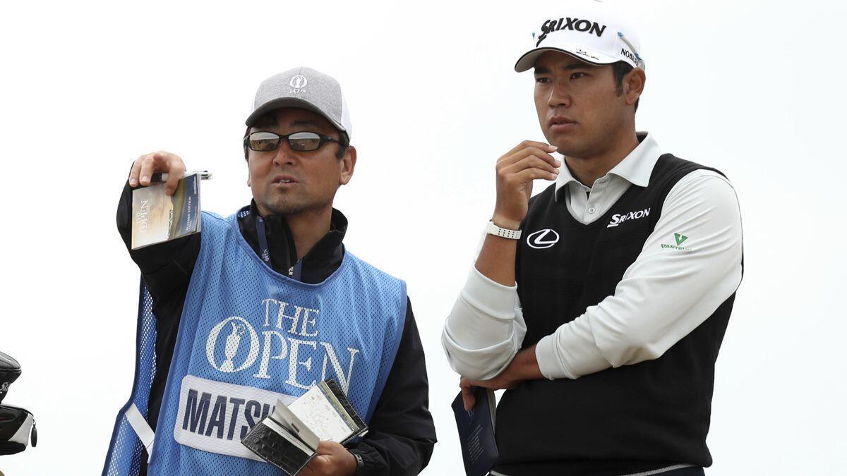 Hideki Matsuyama his caddie look along the third fairway during a practice round ahead of the British Open Golf Championship in Carnoustie, Scotland on Wednesday.