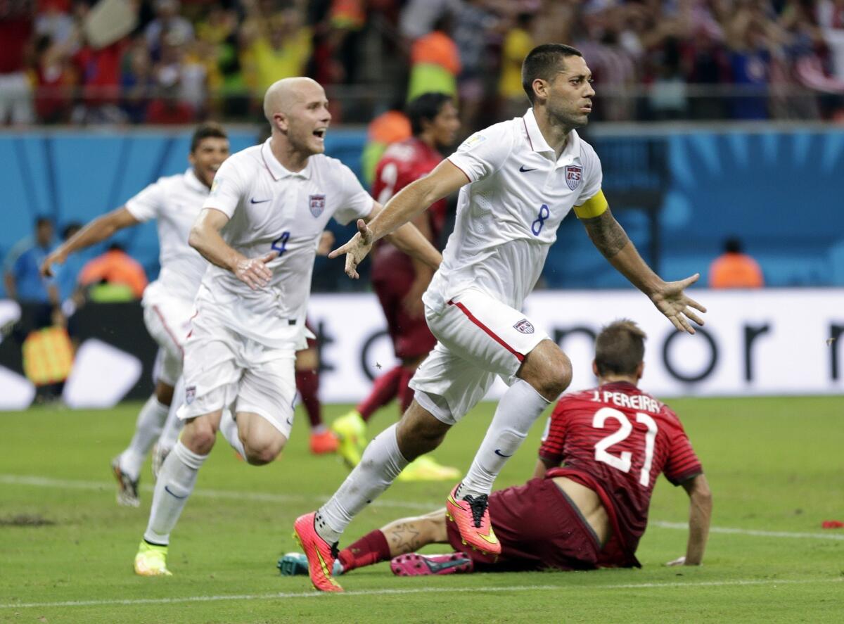U.S. midfielder Michael Bradley (4) and forward Clint Dempsey head to the sideline to celebrate Dempsey's goal against Portugal on Sunday. The U.S. team will advance with a win or tie against Germany on Thursday.