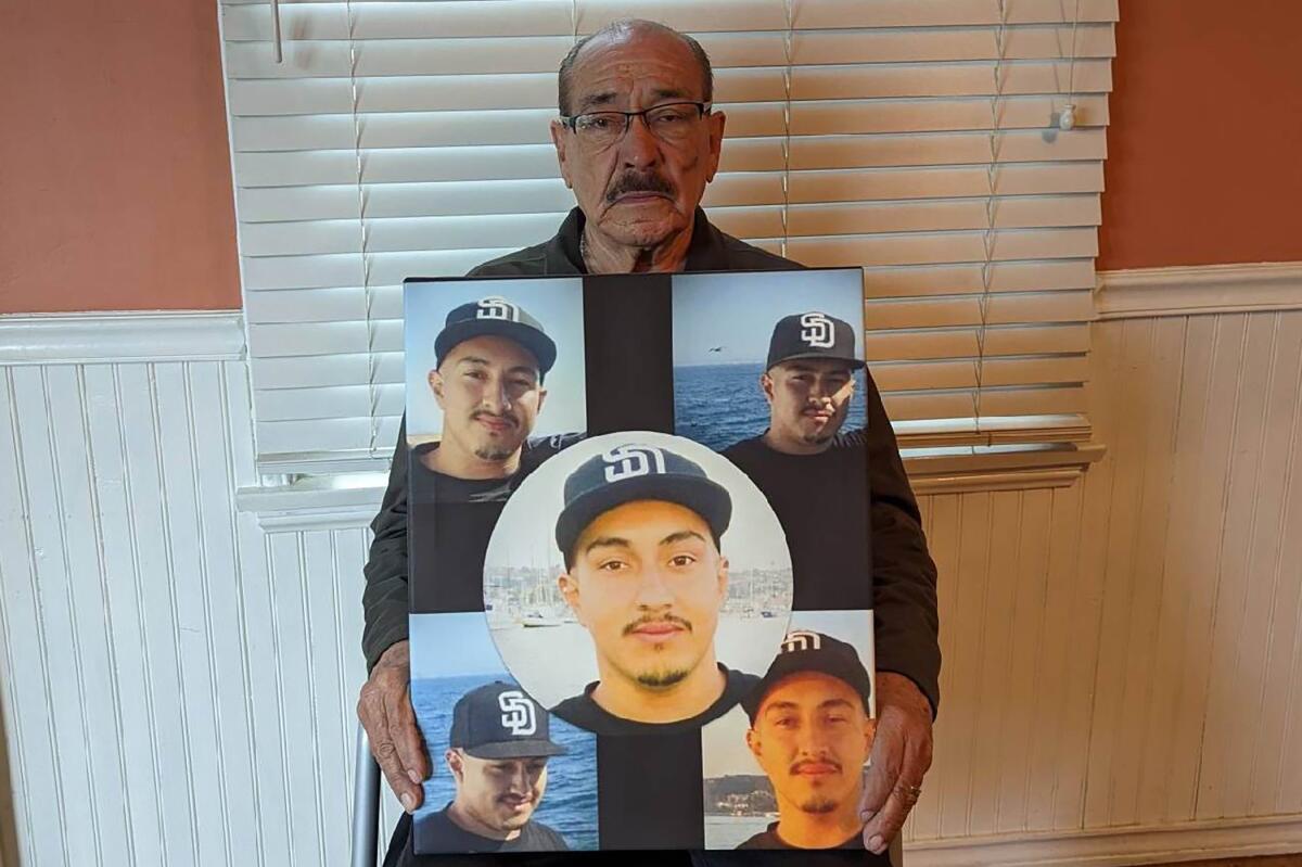 Amado Pantoja holds pictures of his son, John, who died in prison by hanging.