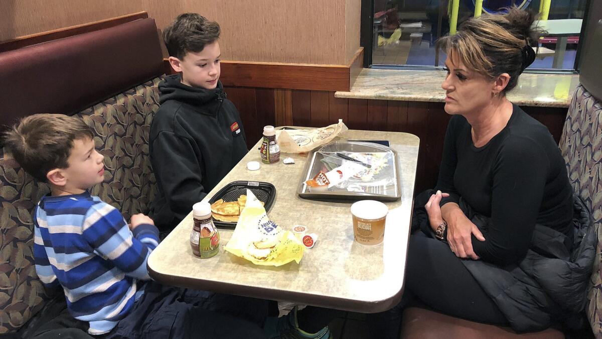 In this Jan. 10, 2019, photo, Tamra Cartwright talks with sons Connor, 7, left, and Caden, 11, about the effect of multiple aftershocks from Alaska's recent magnitude 7 earthquake.