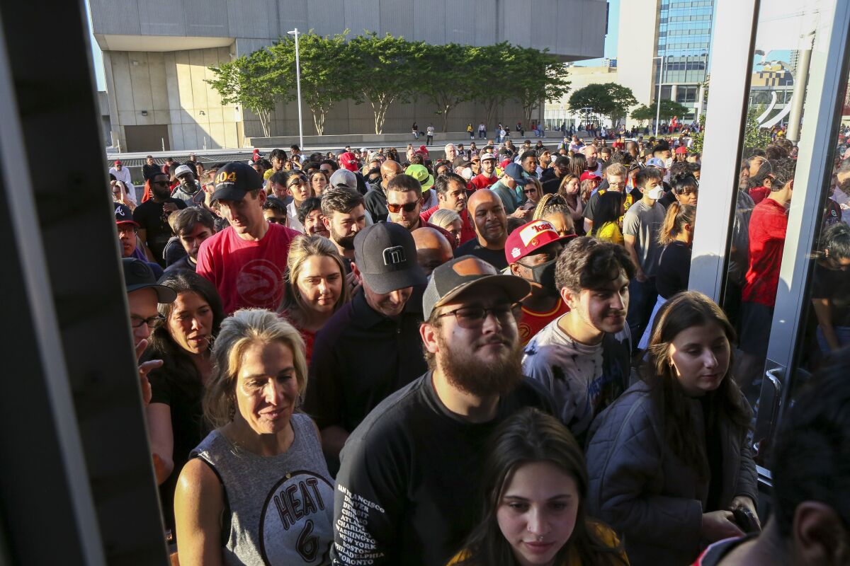 Fans enter a gate after three others were closed because of a suspicious package before Game 3 in Atlanta on April 22, 2022.