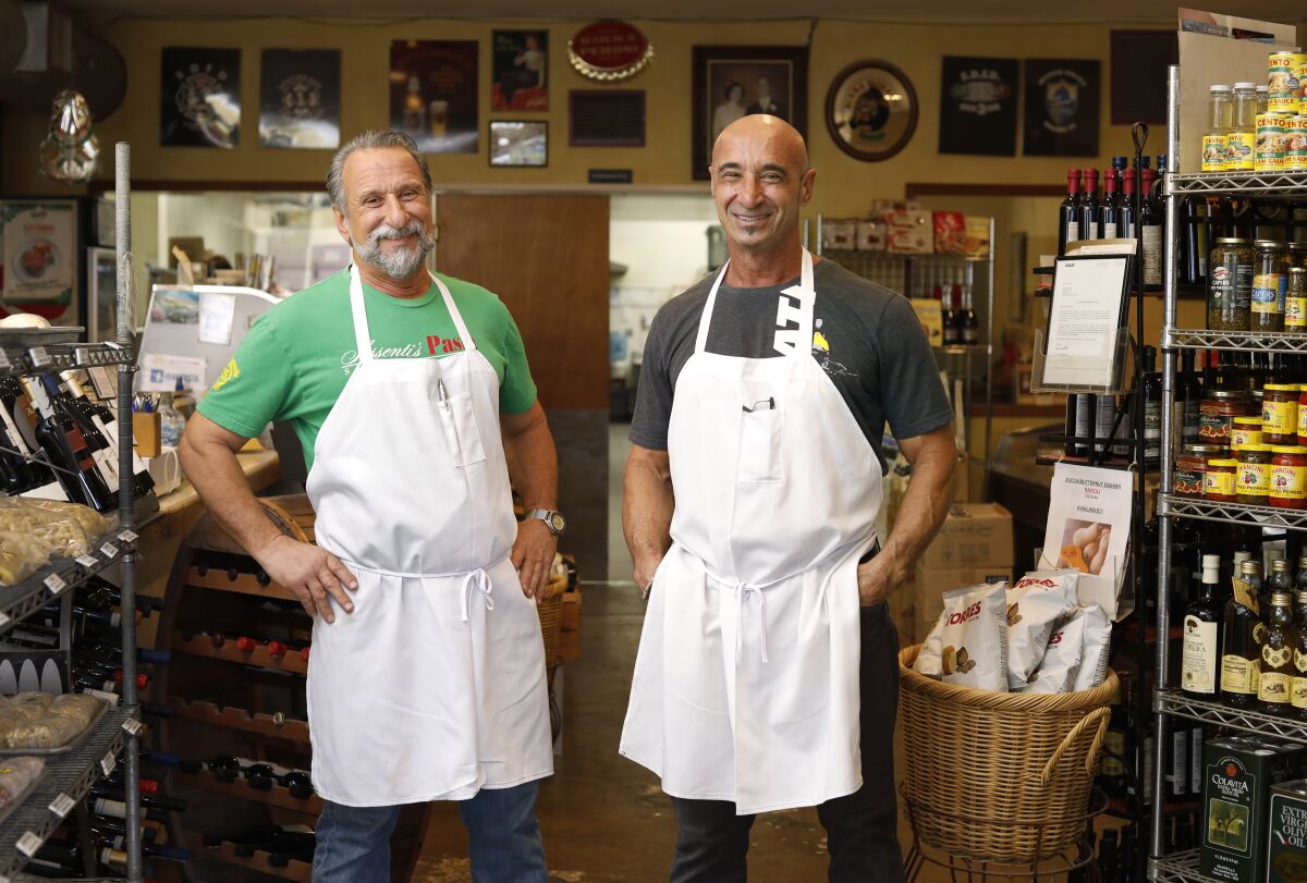 Freshly made pasta is sold at Assenti’s Pasta in Little Italy, owned by Roberto Assenti (left) and his brother Luigi.