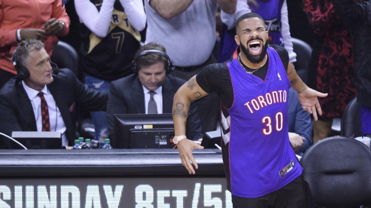 Drake reacts courtside as the Toronto Raptors play the Golden State Warriors in Game 1 of the NBA Finals on Thursday in Toronto.