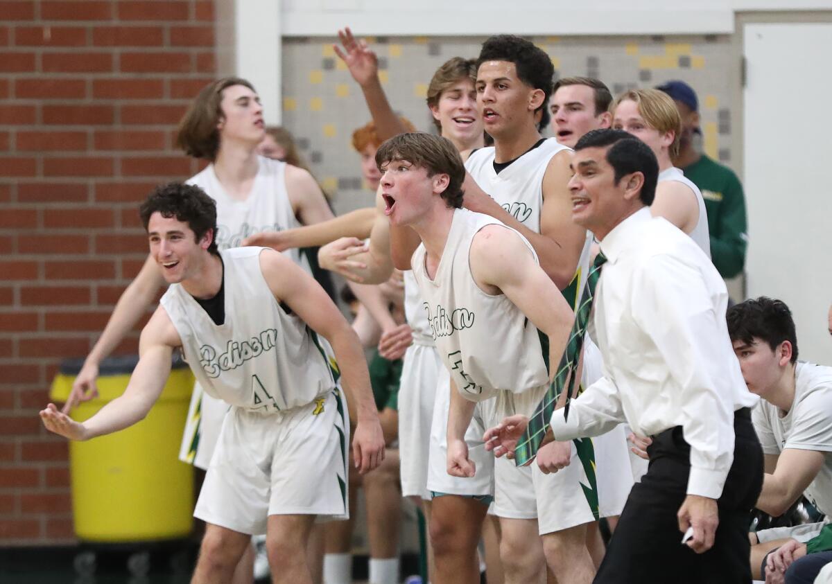 The Edison bench including head coach Rich Boyce, far right, react to a three-point basket.