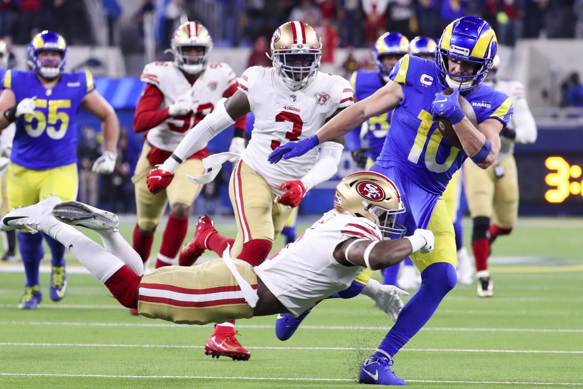 Niners free safety Jimmie Ward tries to tackle Rams wide receiver Cooper Kupp.
