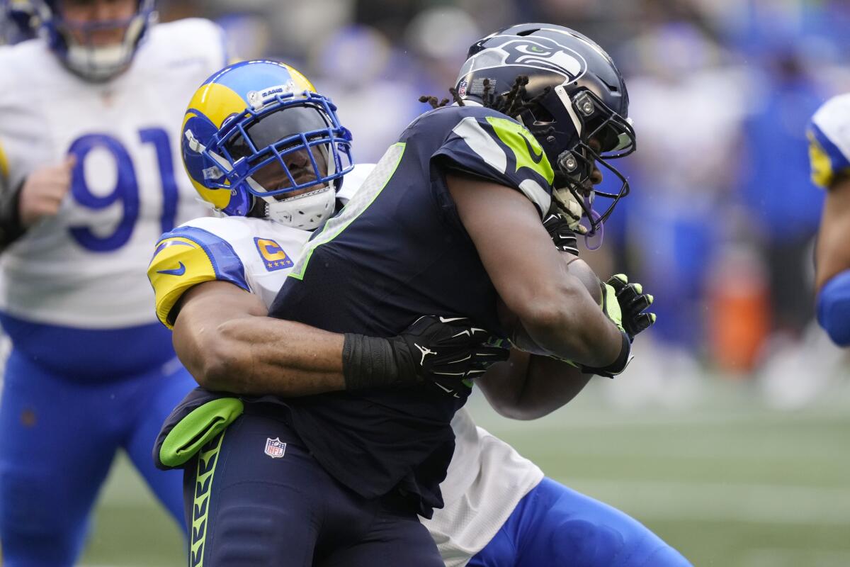 Seattle Seahawks running back DeeJay Dallas is tackled by Rams linebacker Bobby Wagner.