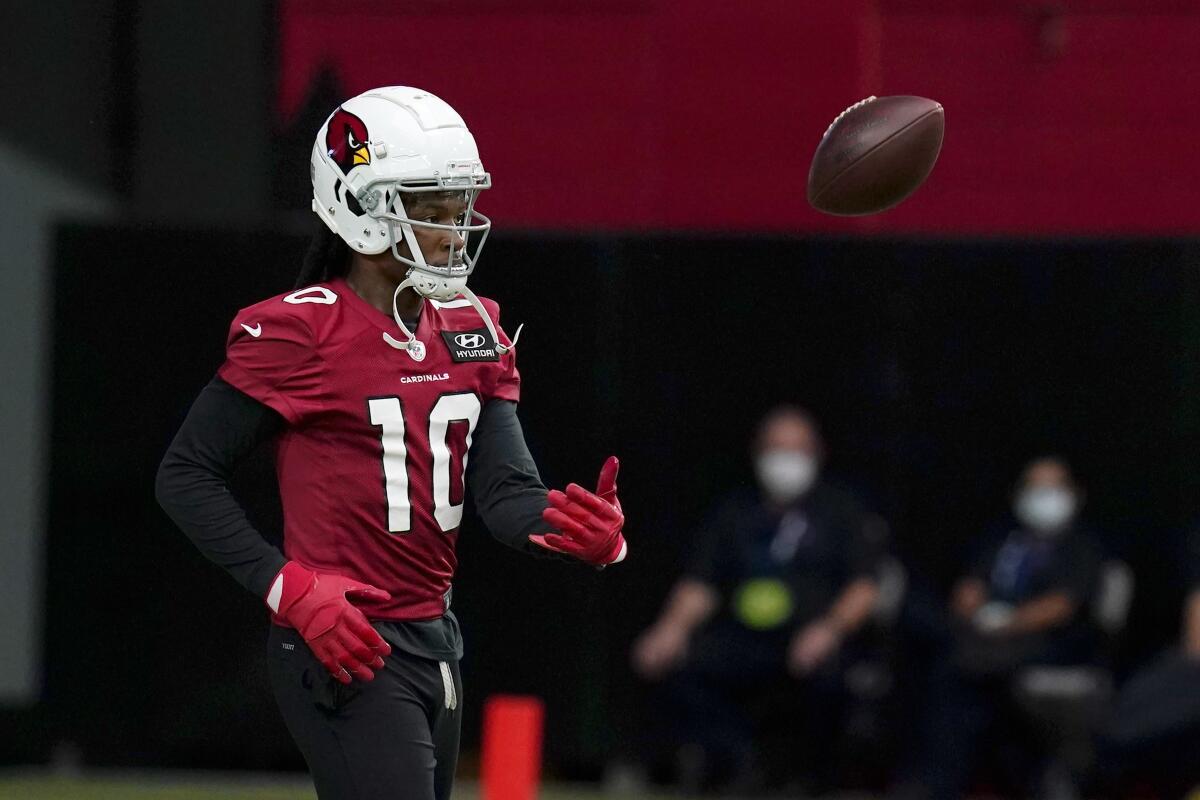 Arizona Cardinals wide receiver DeAndre Hopkins flips the football away after making a catch.